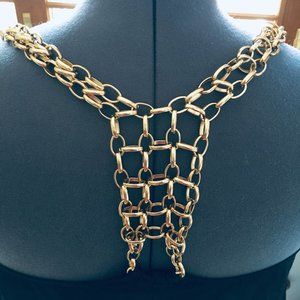 Black, flared tank top with gold metal chain straps, back detail racerback